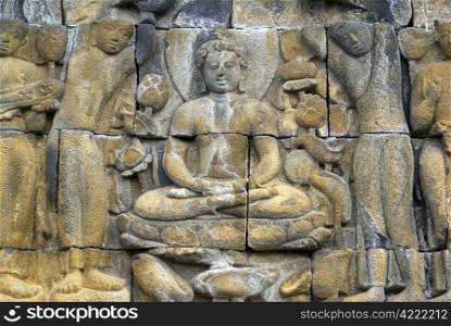 Buddha and women on the wall of Borobudur, Java, Indonesia