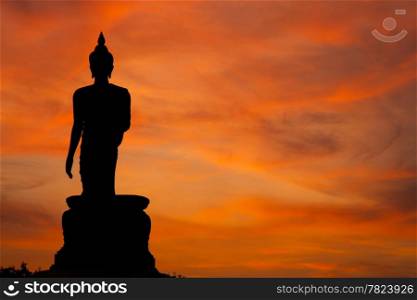 Buddha at sunset. When the evening sun is bright red. Lord Black is a sleek backlit.