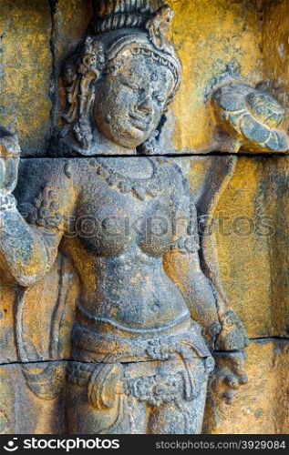 Buddha at the temple Borobudur in Indonesia. Buddha with Lotus encarved in stone