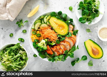 Buddha bowl with grilled chicken breast, avocado and fresh vegetable salad for lunch