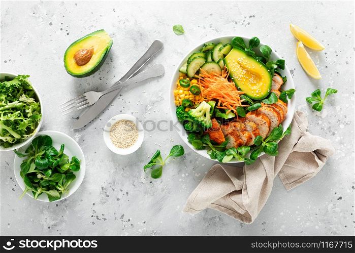 Buddha bowl with grilled chicken breast, avocado and fresh vegetable salad for lunch