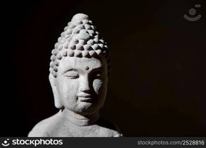 buddha face on a dark background
