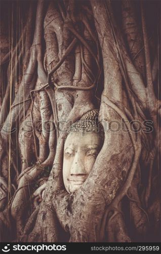 Buddha Head in Tree Roots, Wat Phra Mahathat temple, Ayutthaya, Thailand. Buddha Head in Tree Roots, Wat Mahathat, Ayutthaya, Thailand