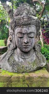 Buddha image in the tropical garden in Bali, Indonesia