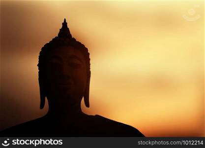 Buddha in thailand with the sky at sunset.