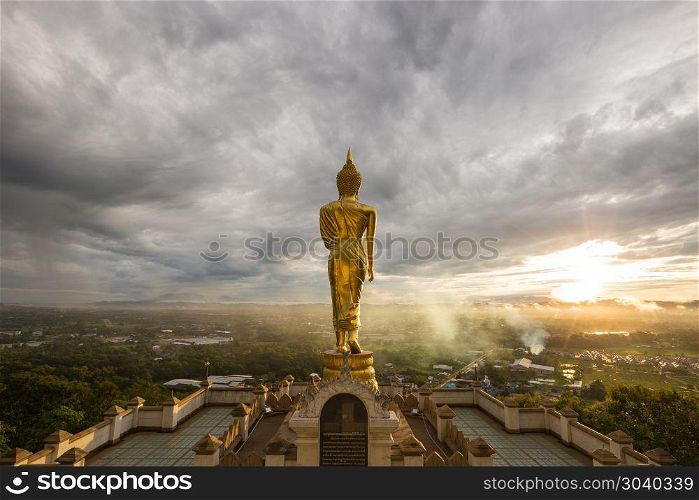 Buddha is on top of the city.. The Buddha is on top of the city. In the morning there are clouds and sunrise in front of the Buddha.