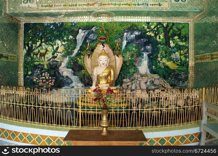 Buddha on green altar in temple, Sagaing Hill, Mandalay, Myanmar