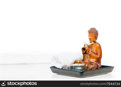 Buddha statue and candle on a white background
