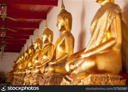 Buddha statue in a temple in a row as the national religion of Thailand.