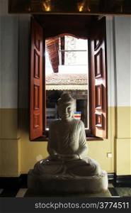 Buddha statue inside Tooth temple in Kandy, Sri Lanka