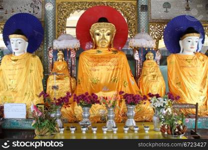 Buddhas and shrine in temple near Shwe dagon pagoda in Yangon, Myanmar