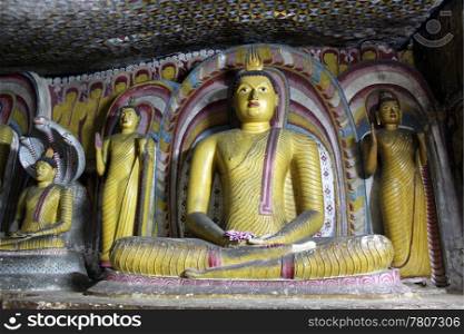 Buddhas at night in cave in Dambulla, Sri Lanka