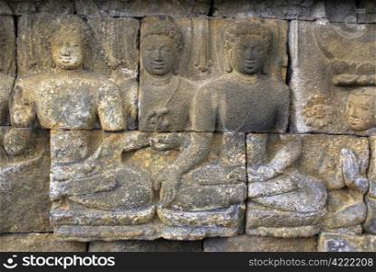 Buddhas on the wall of Borobudur, Java, Indonesia