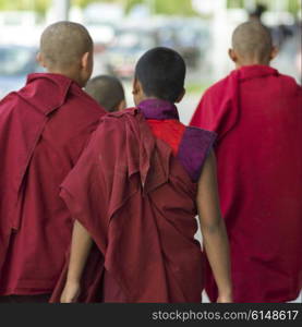 Buddhist monks walking on street, Paro, Bhutan