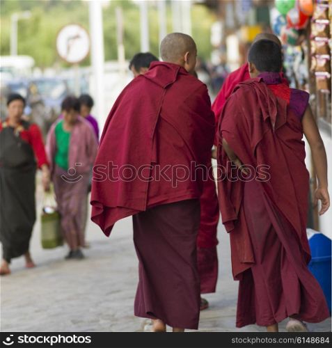 Buddhist monks walking on street, Paro, Bhutan