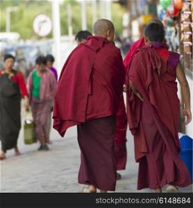 Buddhist monks walking on street, Paro, Bhutan
