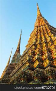 Buddhist pagodas of Wat Pho temple in Bangkok, Thailand. It is 42 meters high and decorated with color-glazed tiles.