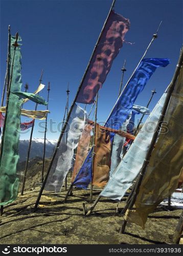 Buddhist prayer flags on a hillside high in the Himalayas in the Kingdom of Bhutan.