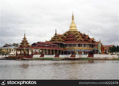 Buddhist temple and boats on the Inle lake, Shan State, Myanmar