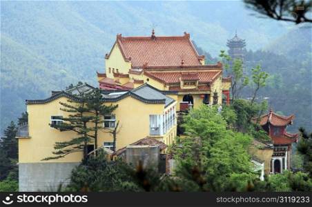 Buddhist temple and pine trees on the mount in Jiuhua Shan, China