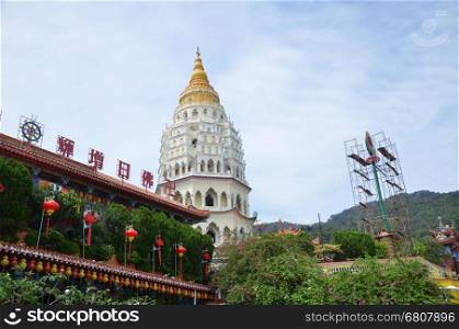Buddhist temple Kek Lok Si in Penang, Malaysia. Chinese writting on the Buddha blessing on top of the building