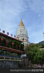Buddhist temple Kek Lok Si in Penang, Malaysia. Chinese writting on the Buddha blessing on top of the building