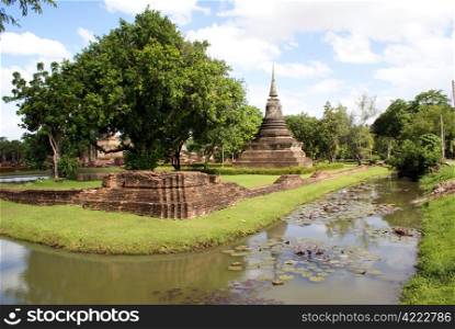 Buddhist wat and moat in old Sukhotai, Thailand