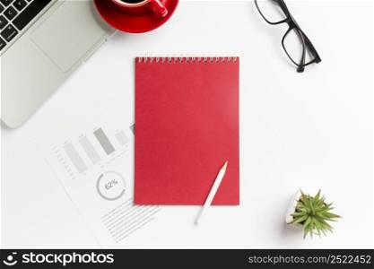 budget chart spiral notepad pencil cactus plant laptop eyeglasses white background