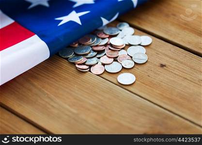 budget, finance, money, crisis and nationalism concept - close up of american flag and cent coins