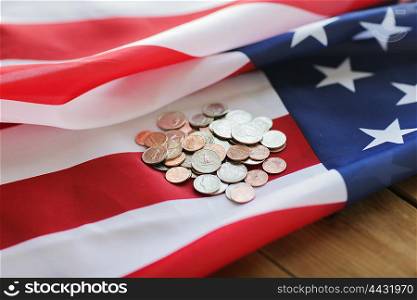budget, finance, money, crisis and nationalism concept - close up of american flag and cent coins