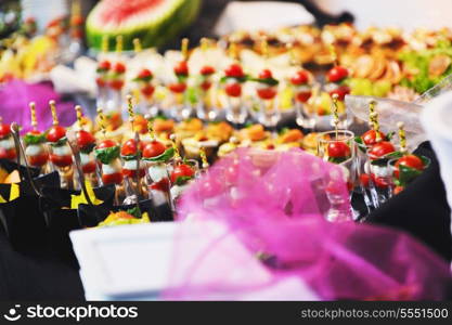 buffed food closeup of fruits, vegetables, meat and fish arranged on banquet table