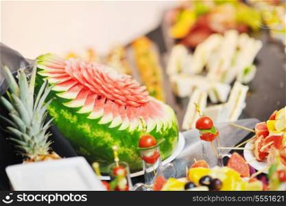 buffed food closeup of fruits, vegetables, meat and fish arranged on banquet table
