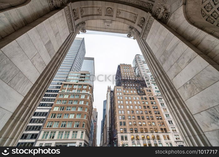 Buidlings of Manhattan framed by arch.