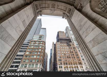 Buidlings of Manhattan framed by arch.