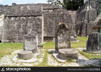 Buig stones near the wall of old temple in Tikal, Guatemala