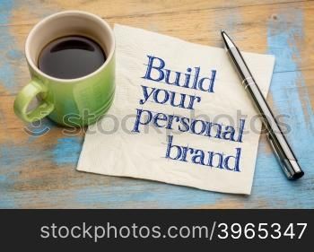 Build your personal brand advice - handwriting on a napkin with a cup of espresso coffee