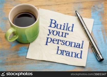 Build your personal brand advice - handwriting on a napkin with a cup of espresso coffee