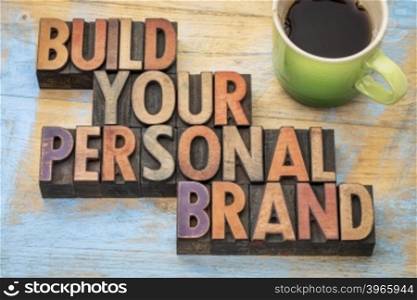 build your personal brand - motivational concept in vintage letterpress wood type block with a cup of coffee