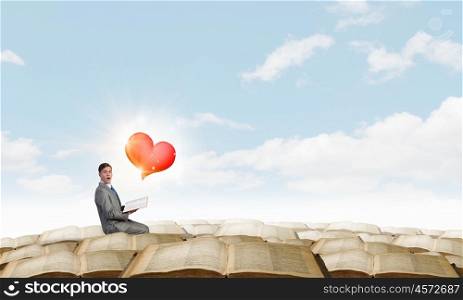 Build your relations. Young emotional businessman with opened book in hand