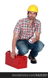 Builder carrying plans and a toolbox