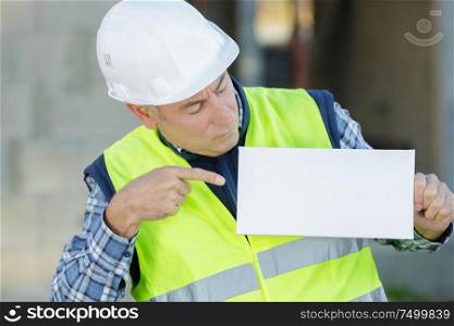 builder - construction worker showing sign
