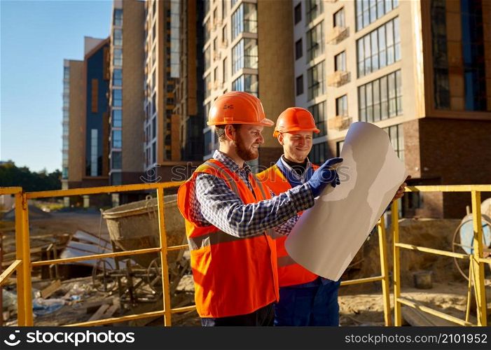 Builder contractor and engineer architect discussing blueprint paper project plan. Construction site. Builder contractor and engineer architect discussing blueprint