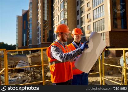 Builder contractor and engineer architect discussing blueprint paper project plan. Construction site. Builder contractor and engineer architect discussing blueprint