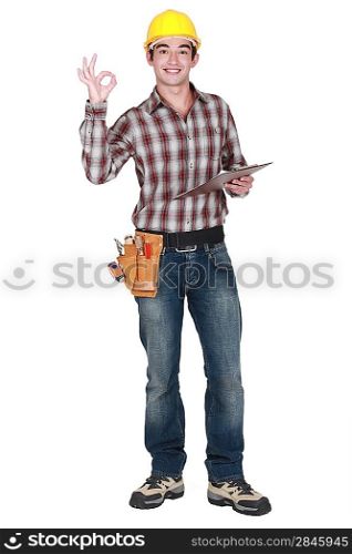 Builder holding clip-board making OK gesture
