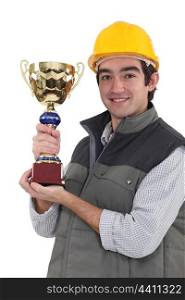 Builder holding trophy