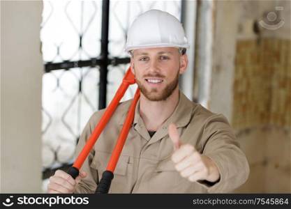 builder in hardhats showing thumbs up
