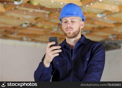 builder man is checking his phone