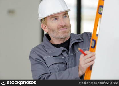 builder man working leveling wall