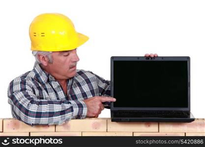 Builder pointing to laptop screen
