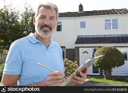 Builder Preparing Estimate For Exterior Home Improvement